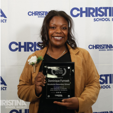 Photo of Dominique Furrowh Brookside ES Teacher of the Year holding plaque